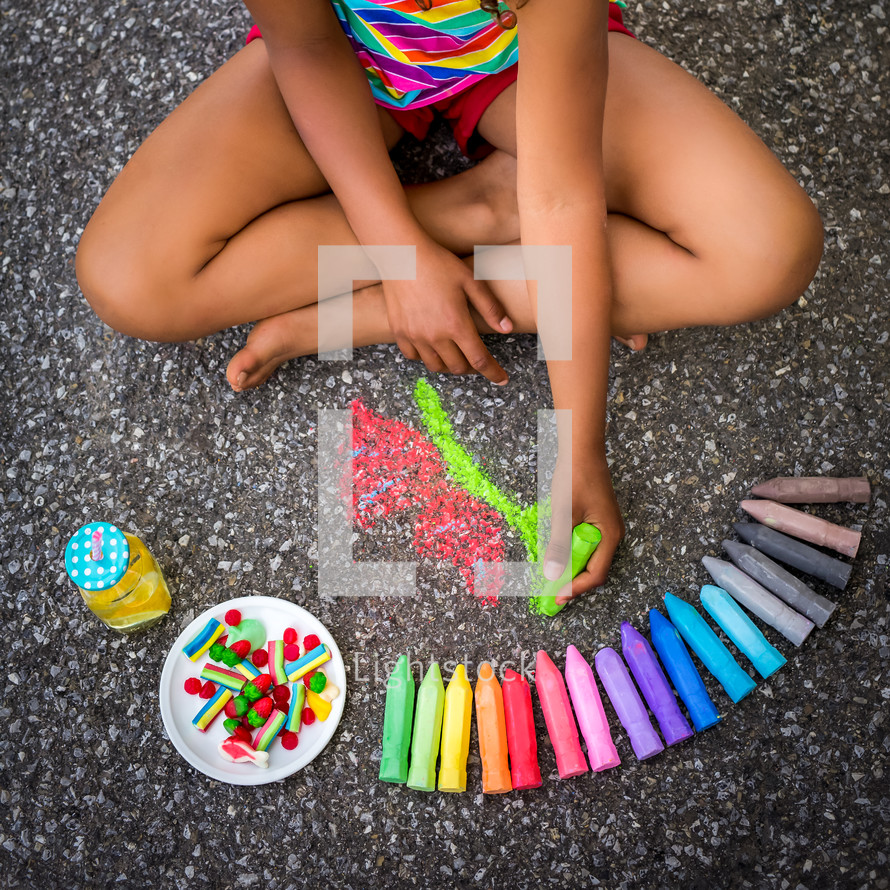 a girl coloring with chalk