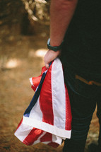 Carrying a folded American flag.