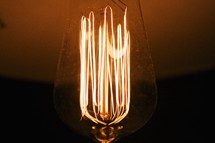 Incandescent light bulb with glowing filament