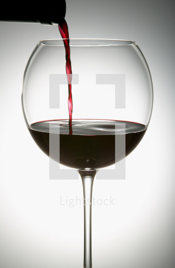 pouring wine into a wine glass 