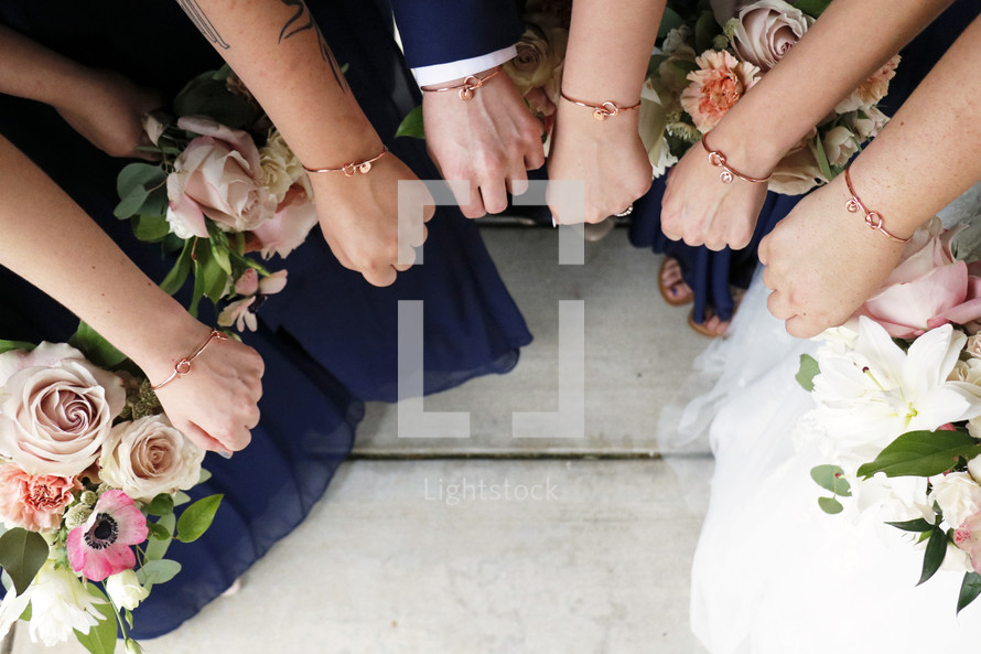 bracelets on the wrists of the bridesmaids and groomsmen 