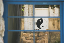 yin yang sign painted on a door 