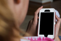 a teen girl holding a cell phone 