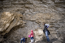 kids pretending to climb a rocky cliff 