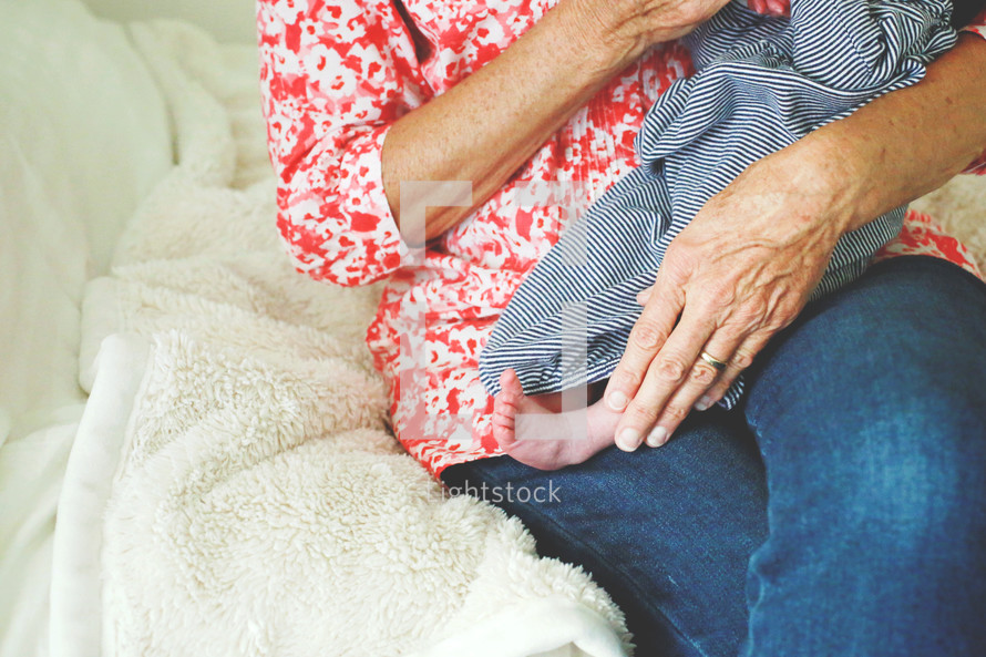 a grandmother cradling a newborn 