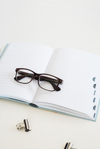 reading glasses on a notebook 