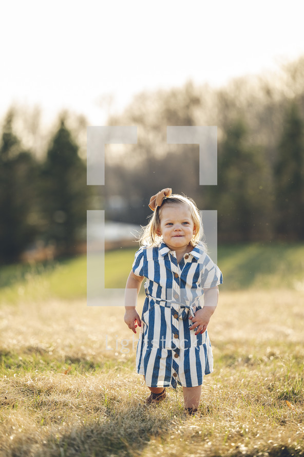 portrait of a little girl in a striped dress 