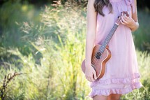 teen girl holding a ukulele 