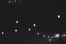string of light bulbs hung from a ceiling 