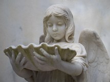 The Angel and the Oyster Shell - A historic statue of a female angel holding an oyster shell reminding us that this life is not the end but there is a place called Heaven.