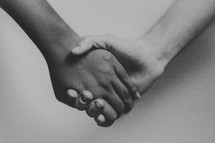 close-up of holding hands against a white background 
