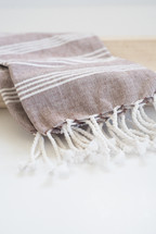 a white and tan linen scarf 