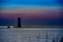 lighthouse at dusk under a purple sky 
