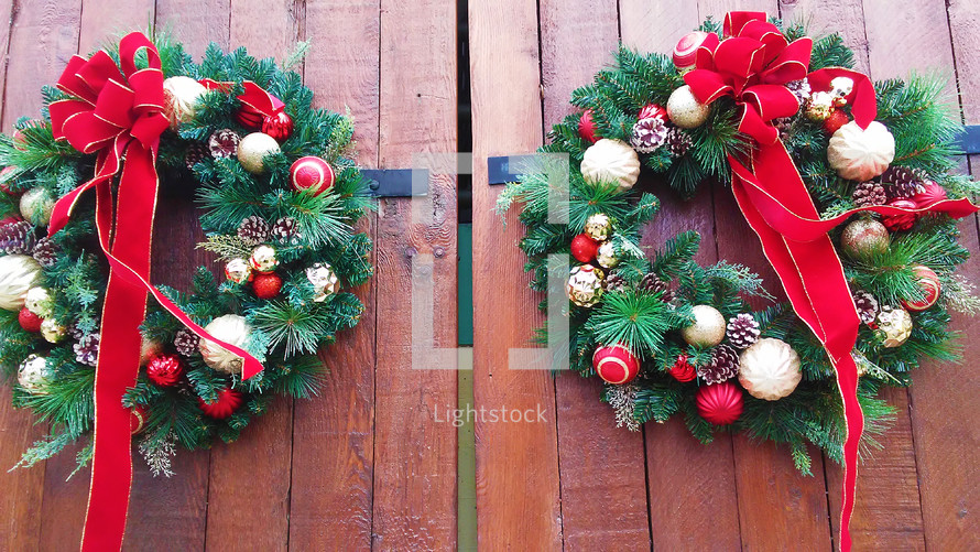Christmas wreaths on red doors 