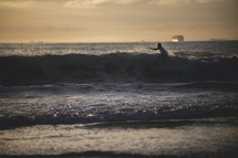 person surfing at sunset 