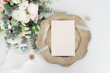 envelope on a silver tray and bouquet of flowers 