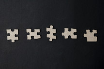 puzzle pieces on a black background 