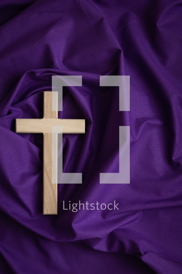 Cross on purple cloth background
