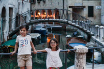 children posing in front of a canal in Venice 