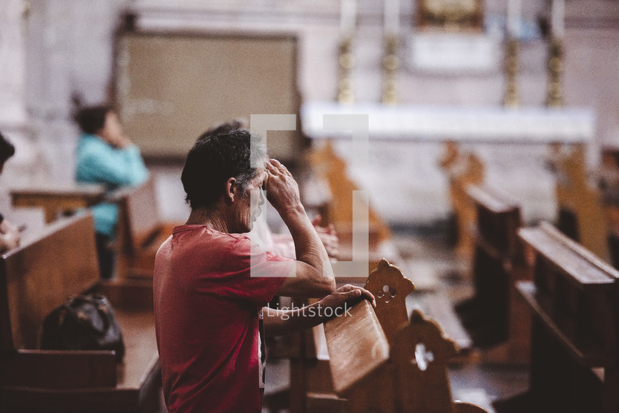 man praying, sign of the cross