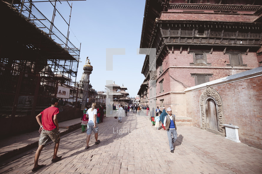 people walking cobblestone streets in Tibet 