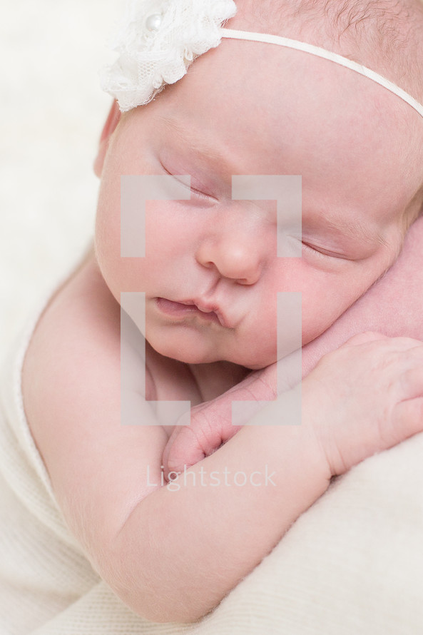 face of a sleeping newborn girl 