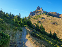 Beautiful morning landscape with a trail to the mountain peak