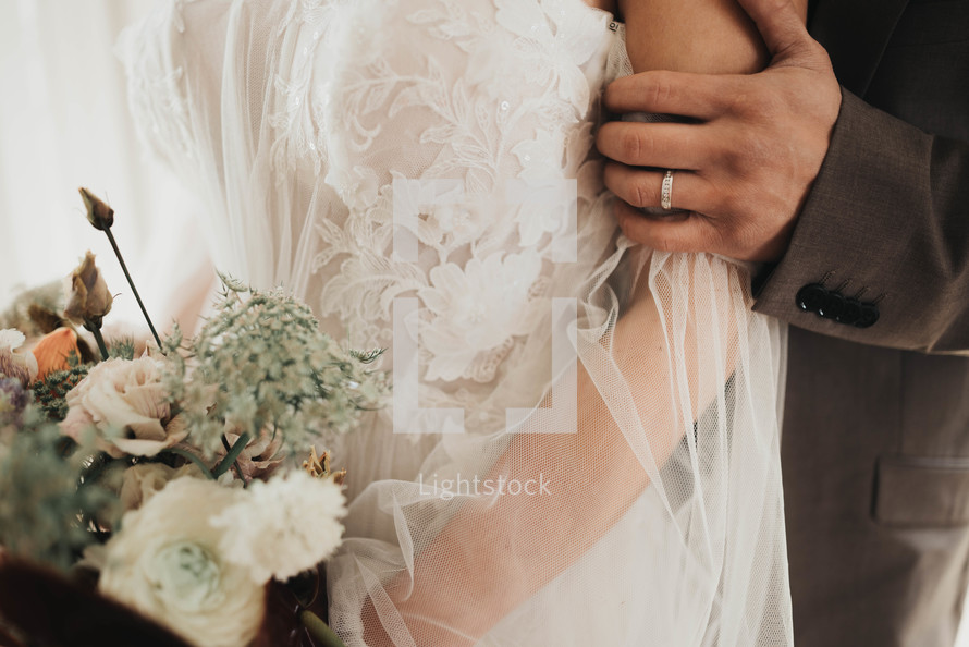 a groom holding a bride's arm