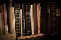 many Bibles on a bookshelf 