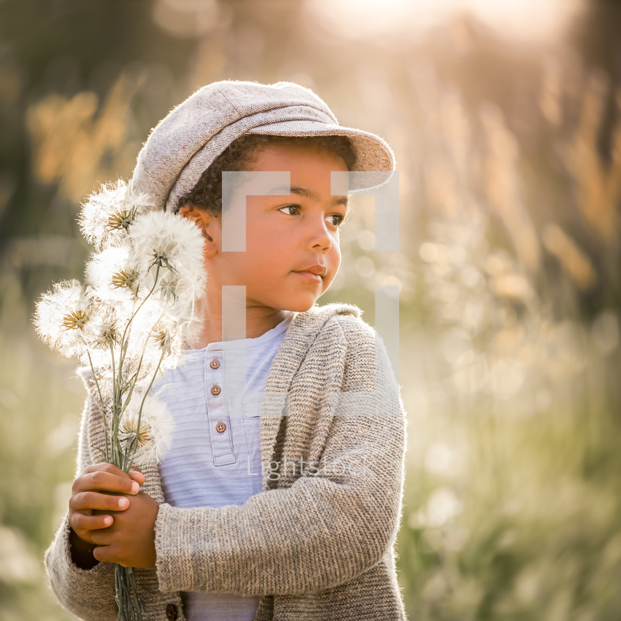 a boy picking flowers 