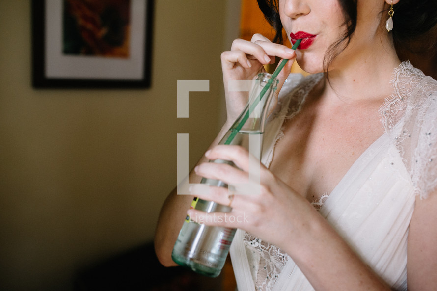 bride sipping out of a straw 