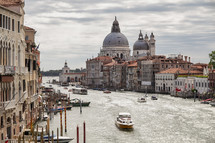 cathedral view and boats on a canal in Venice 