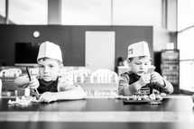 children wearing bakers hats 