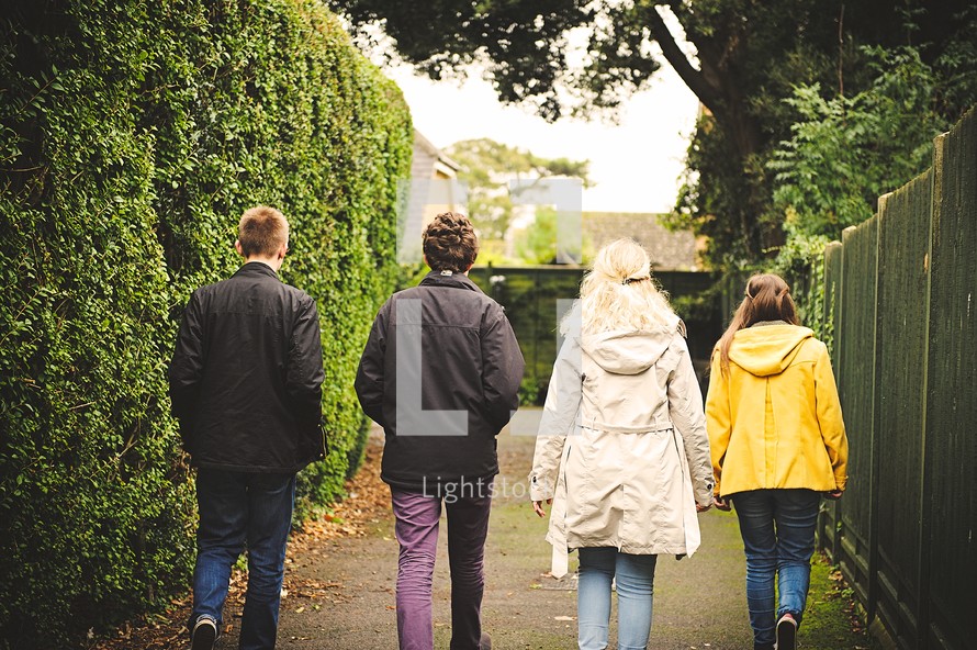 teens walking down a sidewalk together 