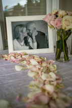 framed picture of a couple and rose petals 