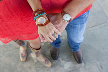 couple, from waist down, holding hands
