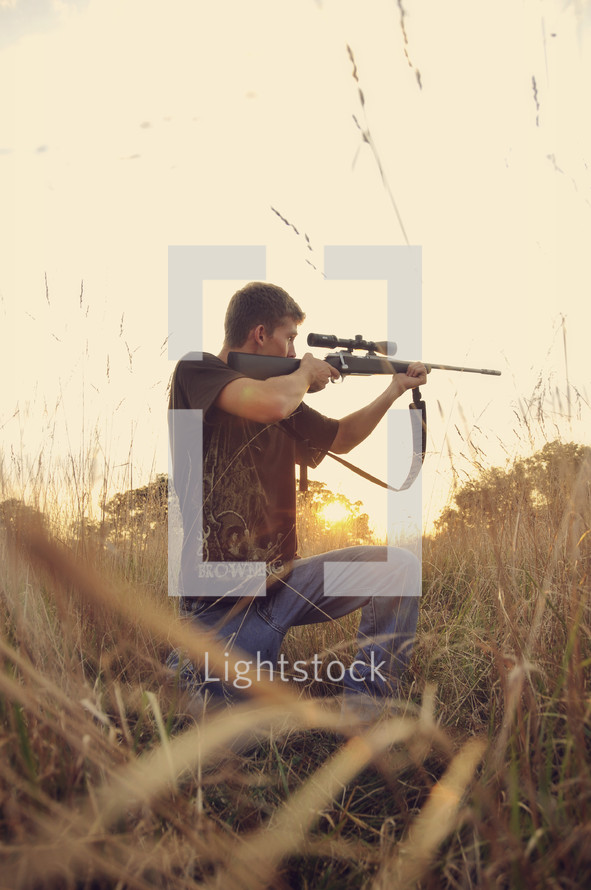 A man aiming a rifle.