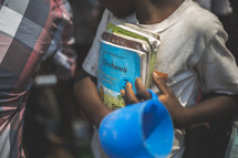 children holding children's Bibles 
