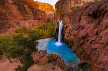 waterfall and red rock cliffs 