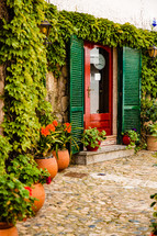 green shutters and red door in Spain 