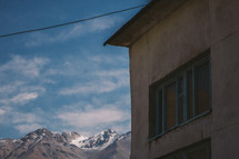 power line over a house and distant mountains 