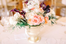 flower arrangement in the center of a table at a wedding reception 