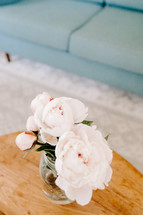 peonies in a vase on a table 