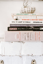 stack of books on a mantle 