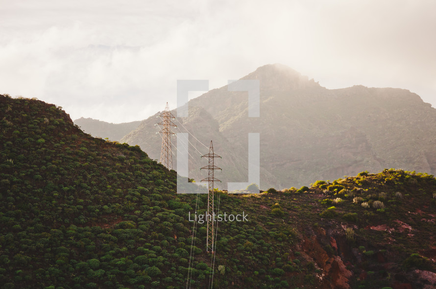 power lines on green mountains in Tenerife, Spain