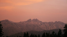 pink sky over a mountain peak 