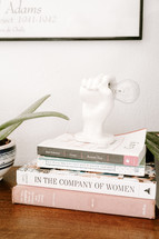 books and figurine on a desk 