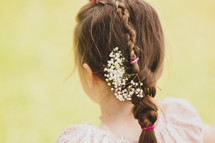 flowers braided into a girls hair 