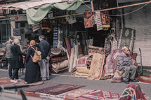 people shopping at an outdoor market 