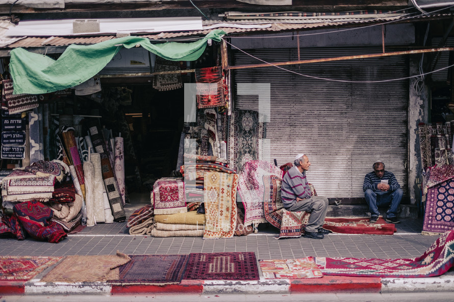 rugs at an outdoors market 